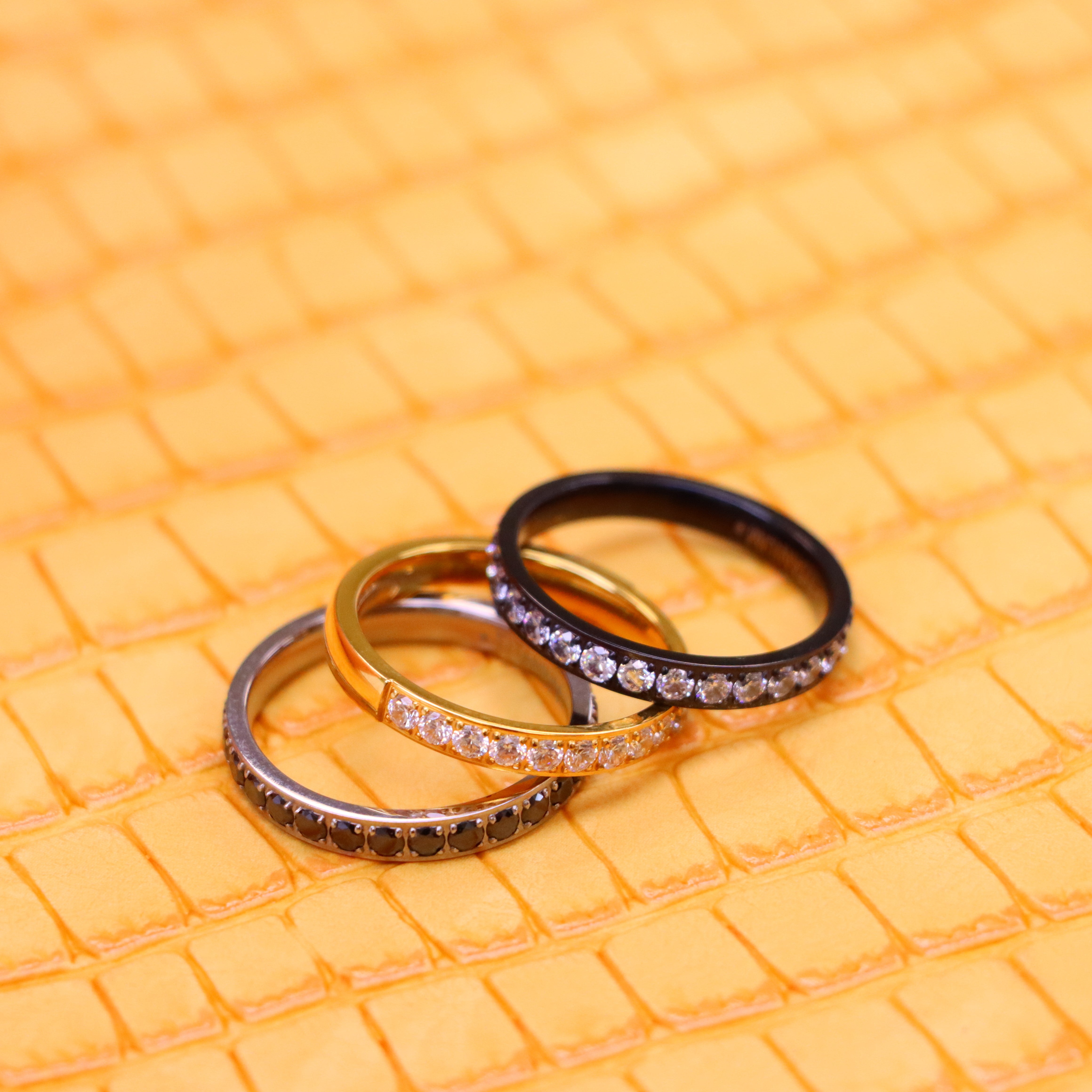 Men's and women's 3mm Yellow Gold, Black Plated Full Eternity White CZ Band and 3mm titanium ring Full Eternity black CZ Band one on one spreaded view