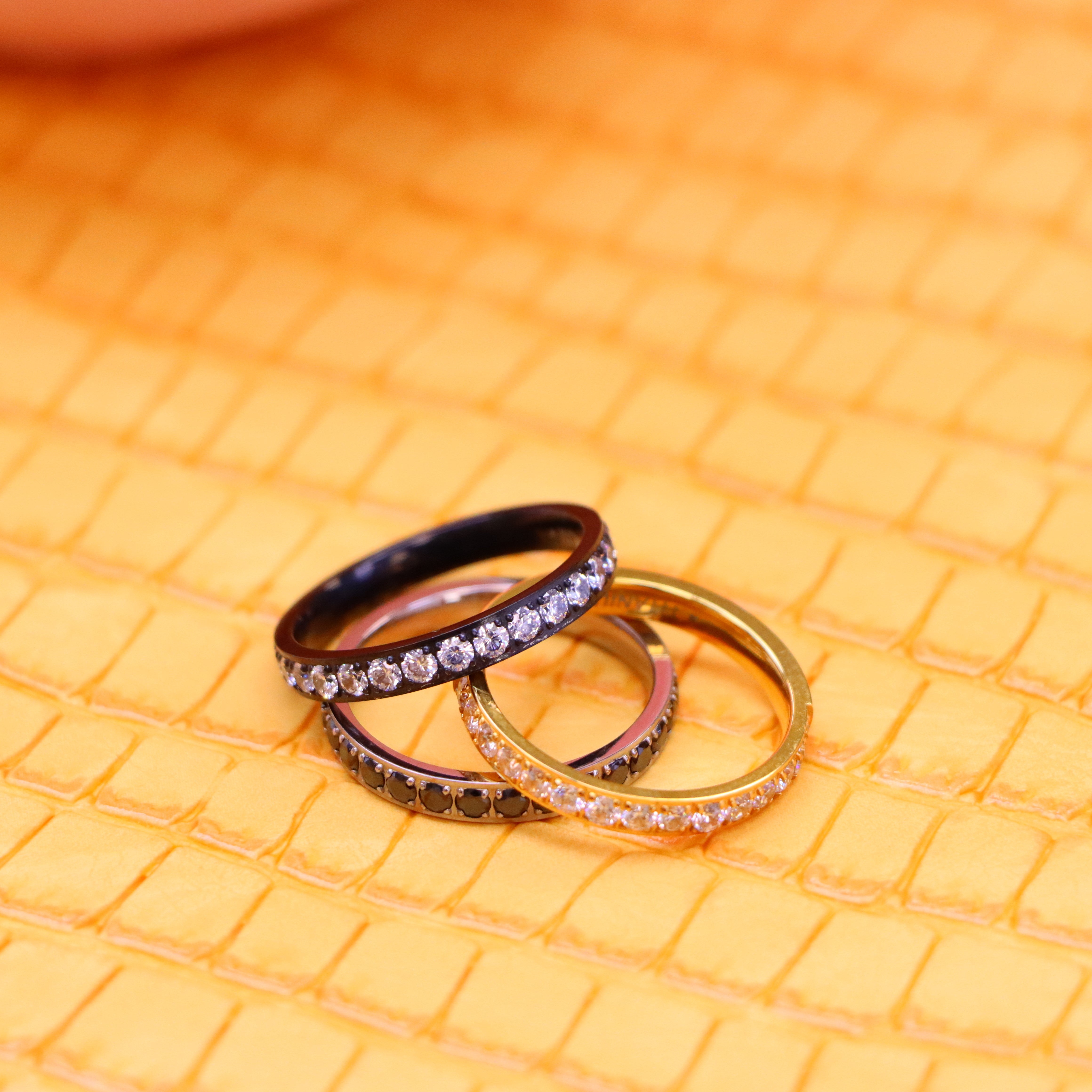 Men's and women's 3mm Yellow Gold, Black Plated Full Eternity White CZ Band and 3mm titanium ring Full Eternity black CZ Band one on one stack view