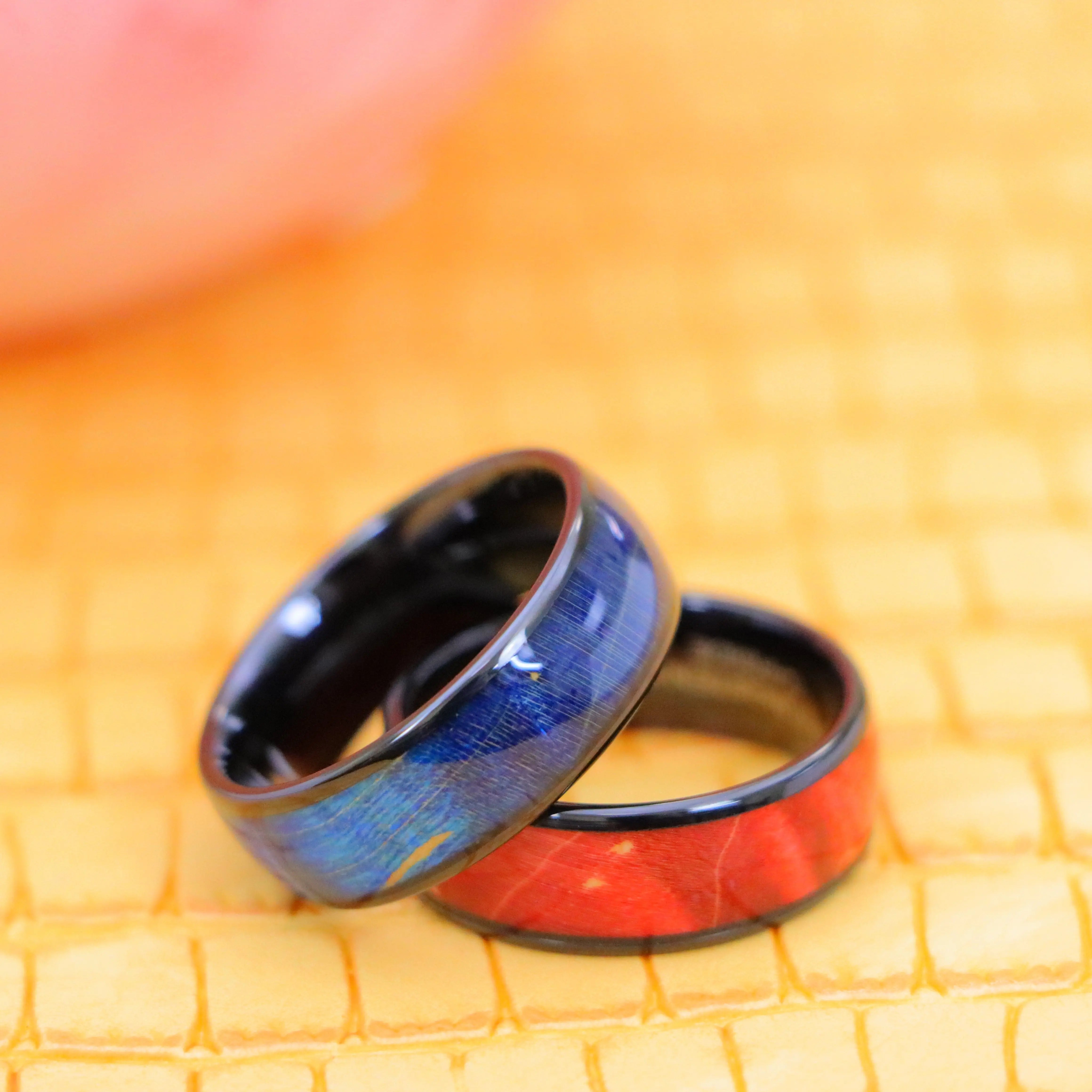 8mm Black IP Domed Azure Stain Stabilized Wood inlay men's tungsten band and 8mm Red Burgundy Hue Solidified Wood Inlay men's Tungsten Ring for Men's Regular wear - one on one spreaded view