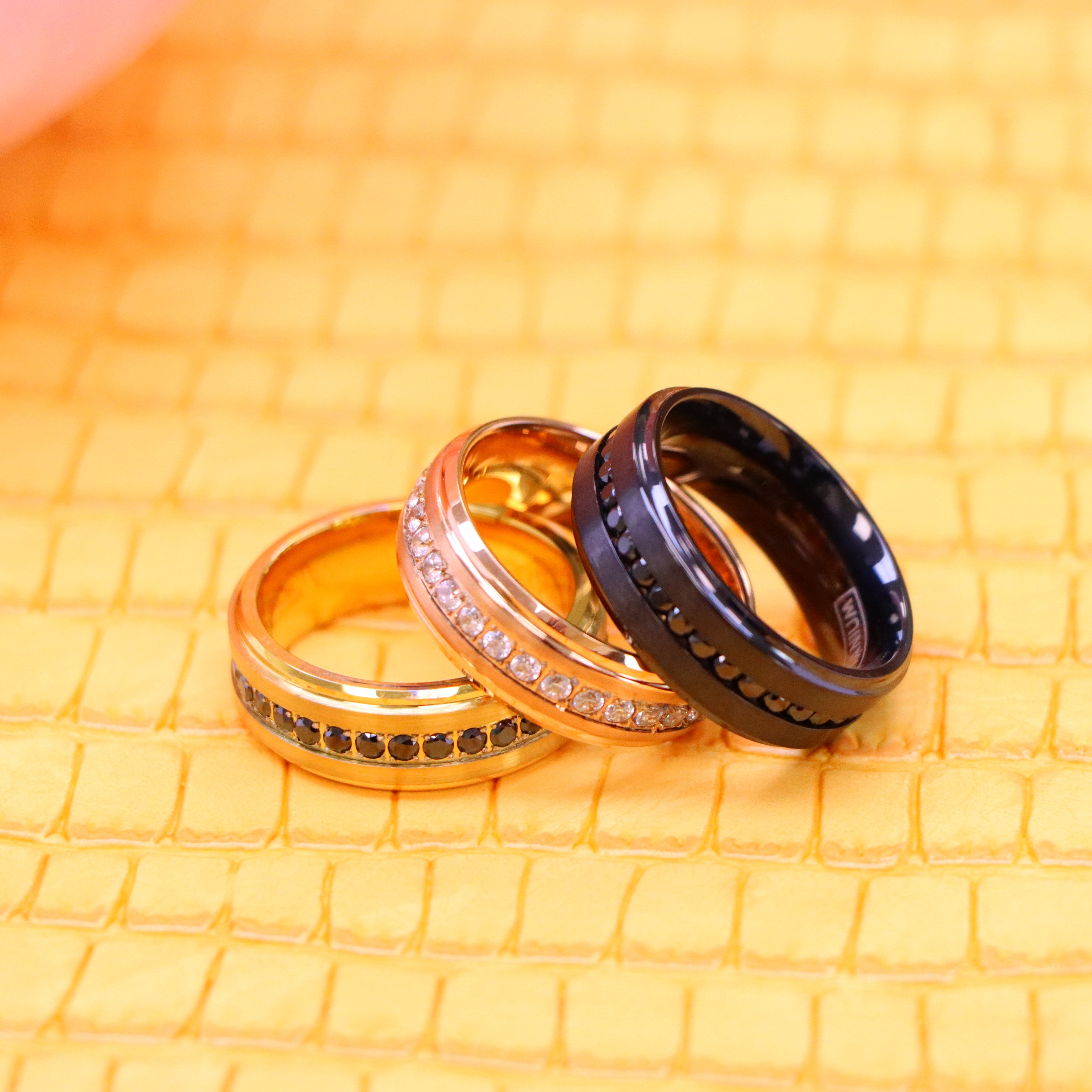 8mm Black IP Plated Titanium Beveled Edge Black CZ Eternity Band, Rose Gold IP Plated White CZ Round Cut Eternity Tungsten Ring and Yellow Gold IP Plated White CZ Round Cut Eternity wedding Tungsten Ring for men - One on one spreaded view