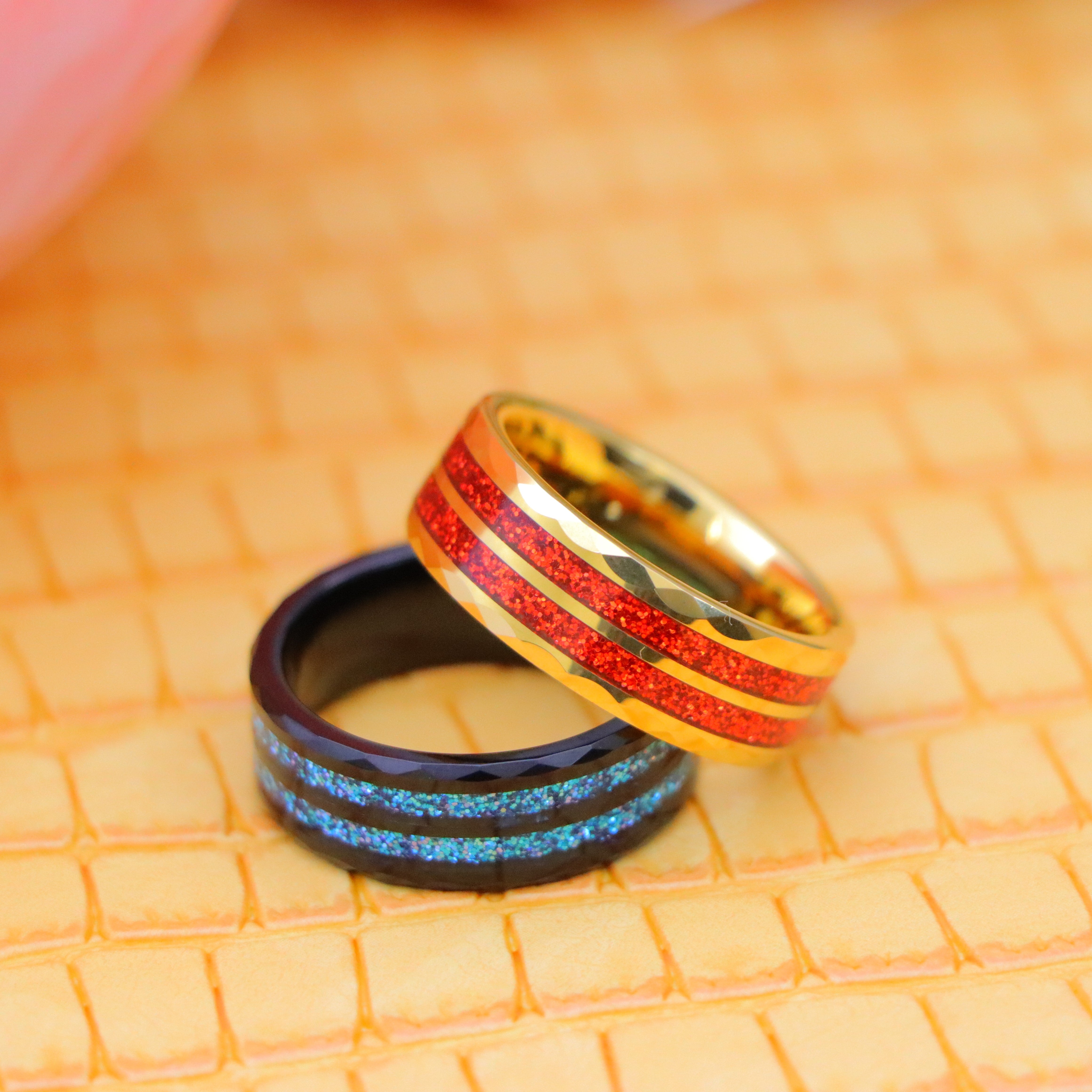 8mm Black IP Plated ring with blue glitter inlay and 8mm Yellow IP Plated ring with Red Glitter Inlay men's tungsten ring - one on one spreaded view