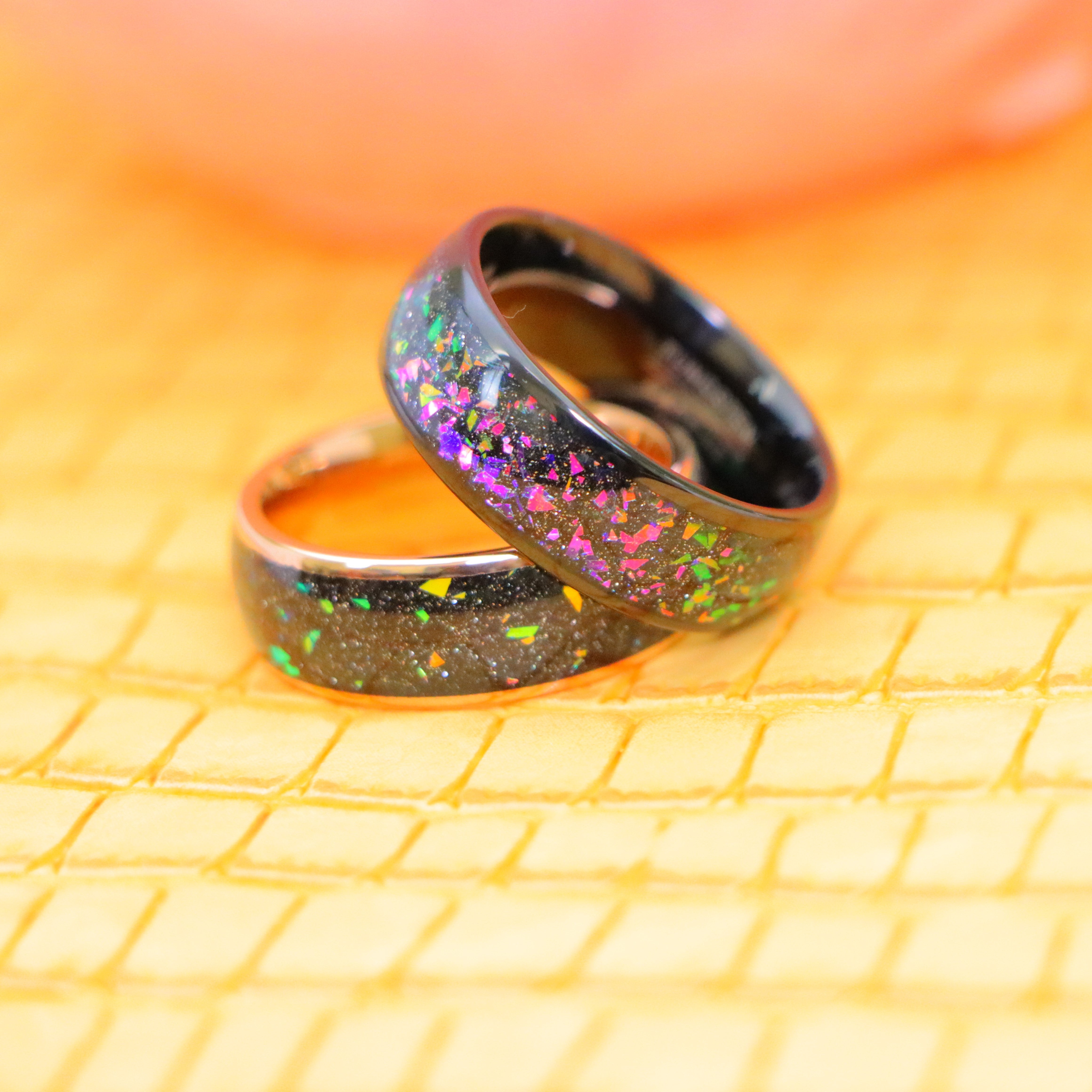 Rose Gold Domed with Synthetic Opal & Abalone Fragments Inlay Tungsten Ring on 8mm Black Domed with Synthetic Opal & Abalone Fragments Inlay Tungsten Ring - One on one spreaded view