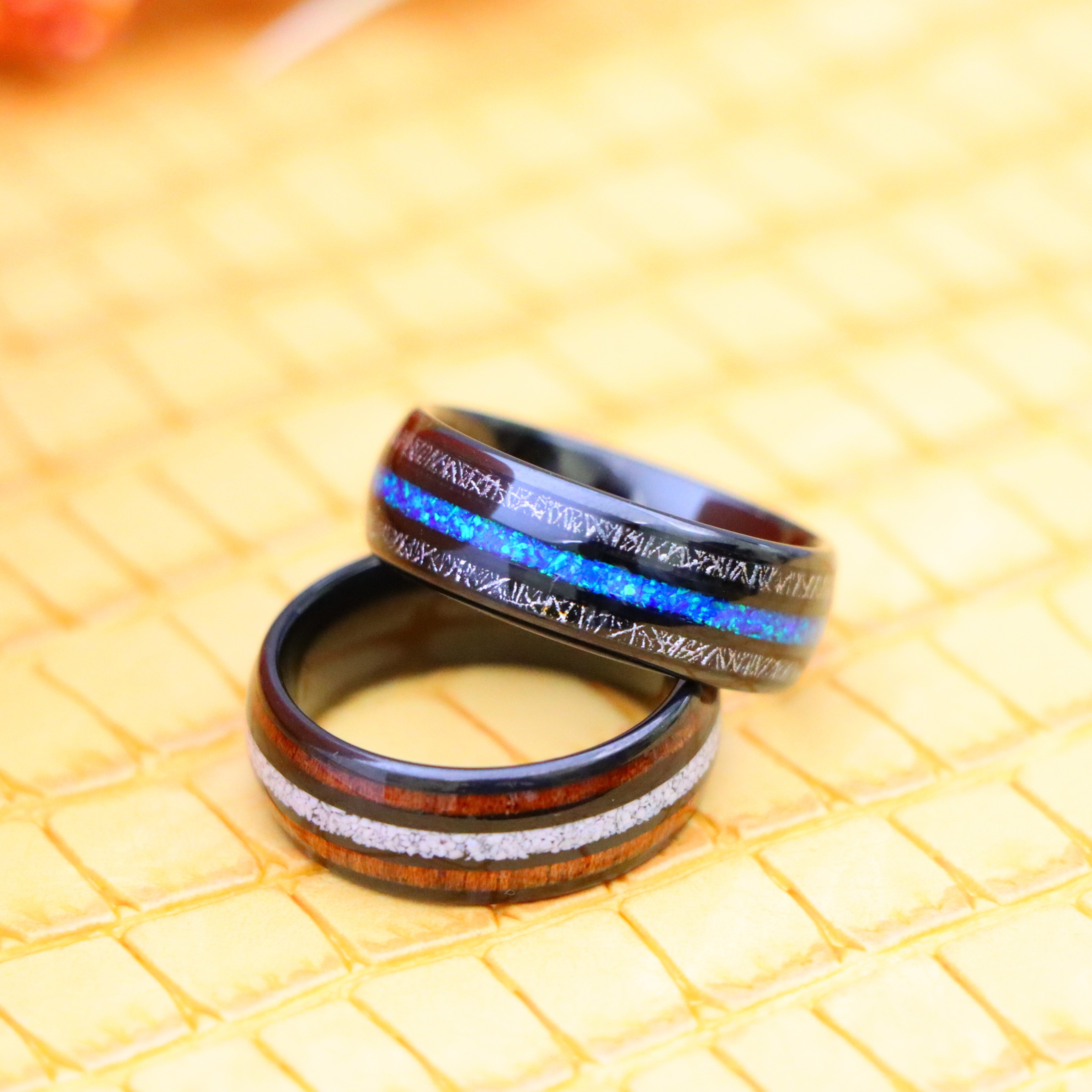 8mm Black IP Plated Koa & Crushed White Turquoise Inlay tungsten ring for pure and wise people and 8mm Black IP Plated Titanium Scraps & fake Opal Inlay Tungsten Ring - one on one spreaded view
