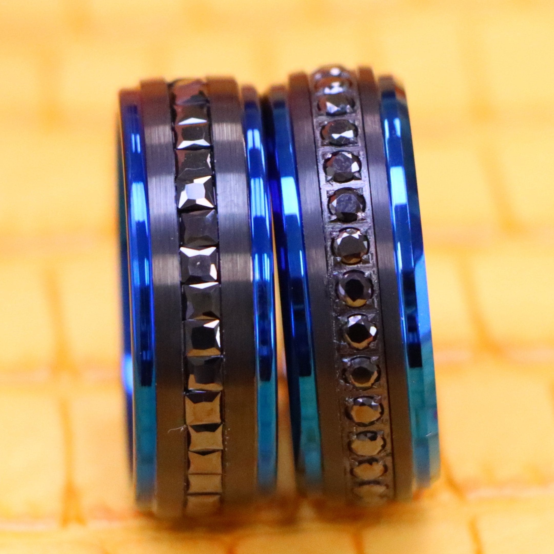 8mm Black Plated with Blue Edges and Black CZ Princess Cut Eternity band and 8mm Black Plated with Blue Edges and Black CZ Round Cut Eternity Ring - clear front view of men and women tungsten rings