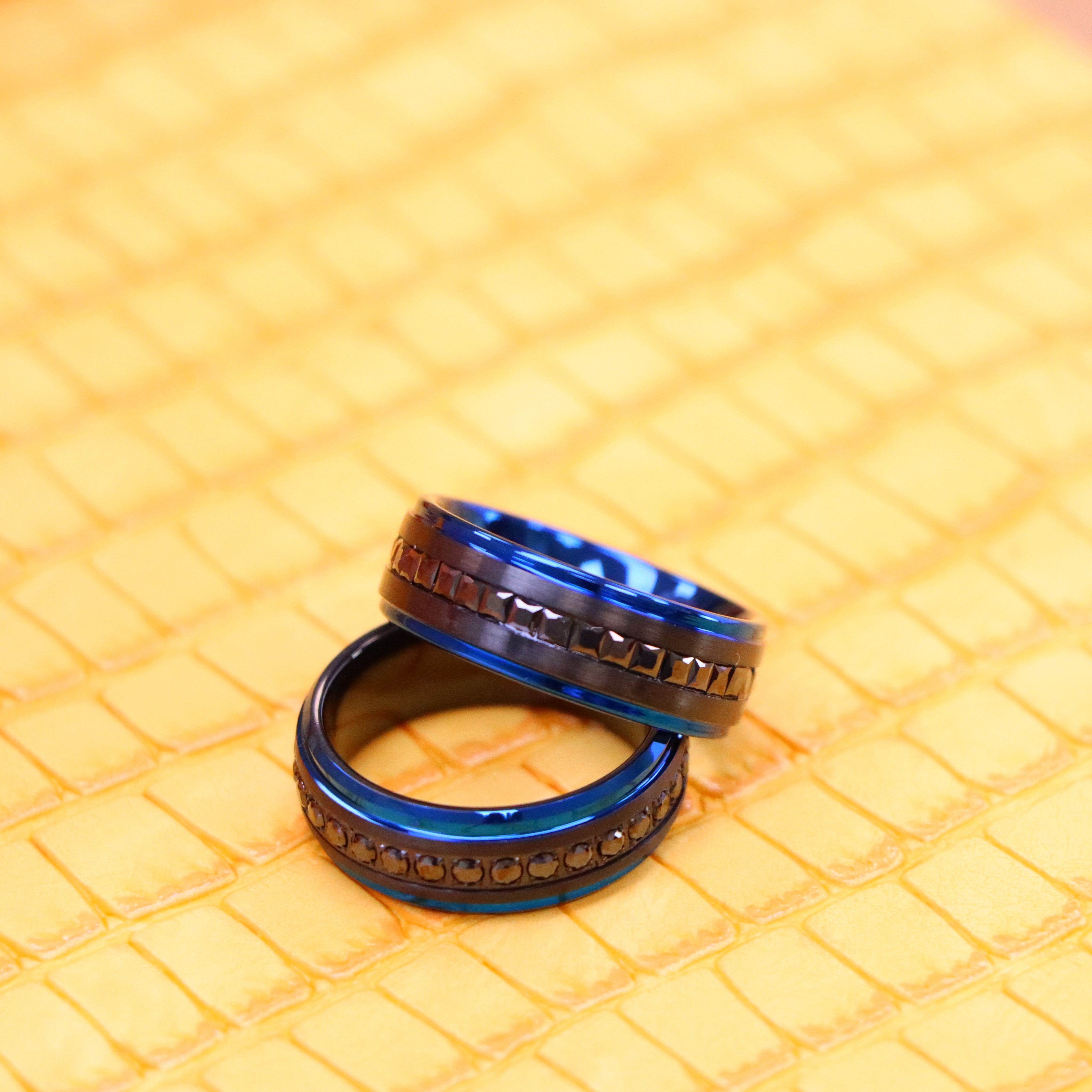 8mm Black Plated with Blue Edges and Black CZ Princess Cut Eternity band and 8mm Black Plated with Blue Edges and Black CZ Round Cut Eternity Ring - one one one spreaded view of men and women tungsten rings