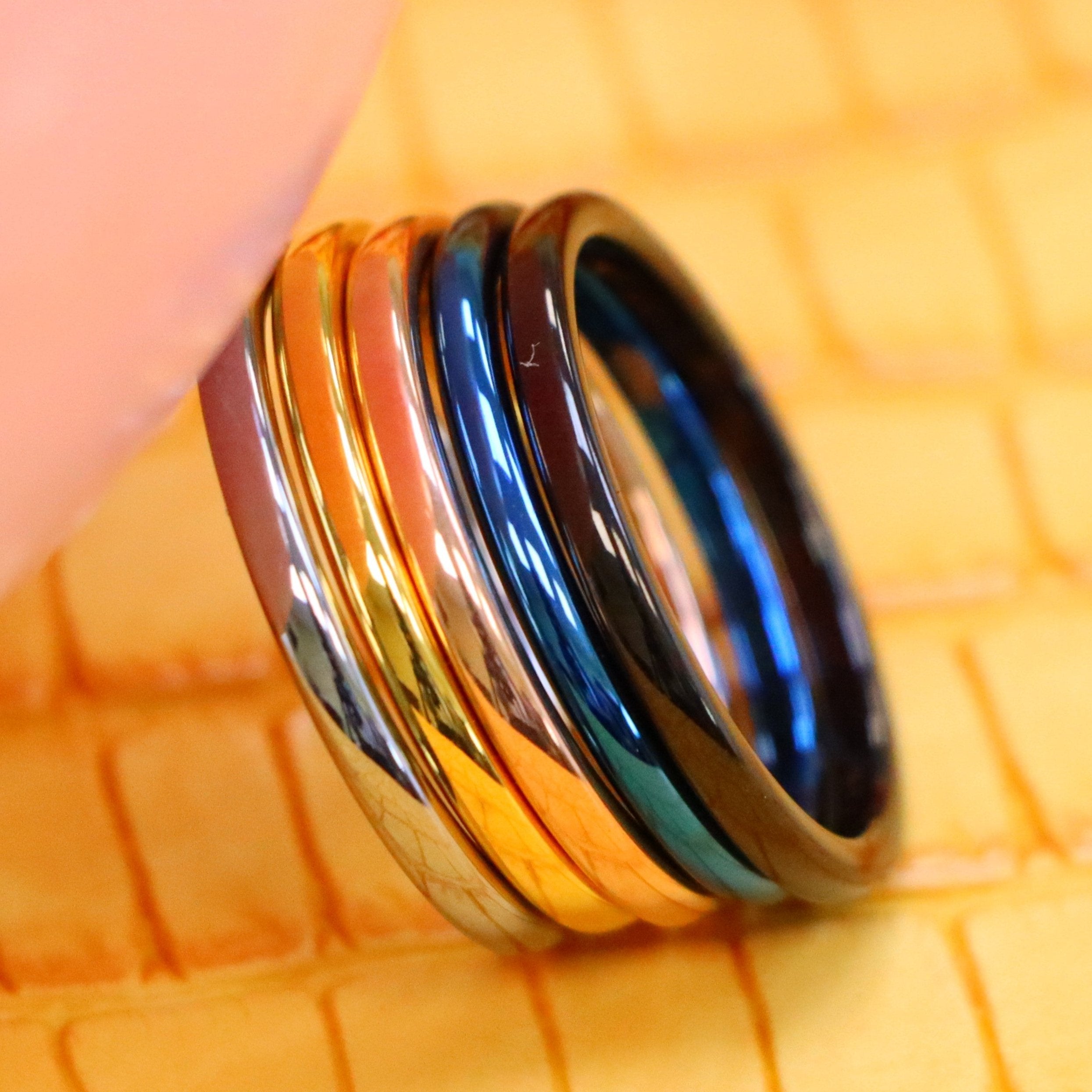 2mm High Polish Blue/Silver/Yellow/Rose Gold/Black Thin multi color Tungsten Rings supported with a finger from left side