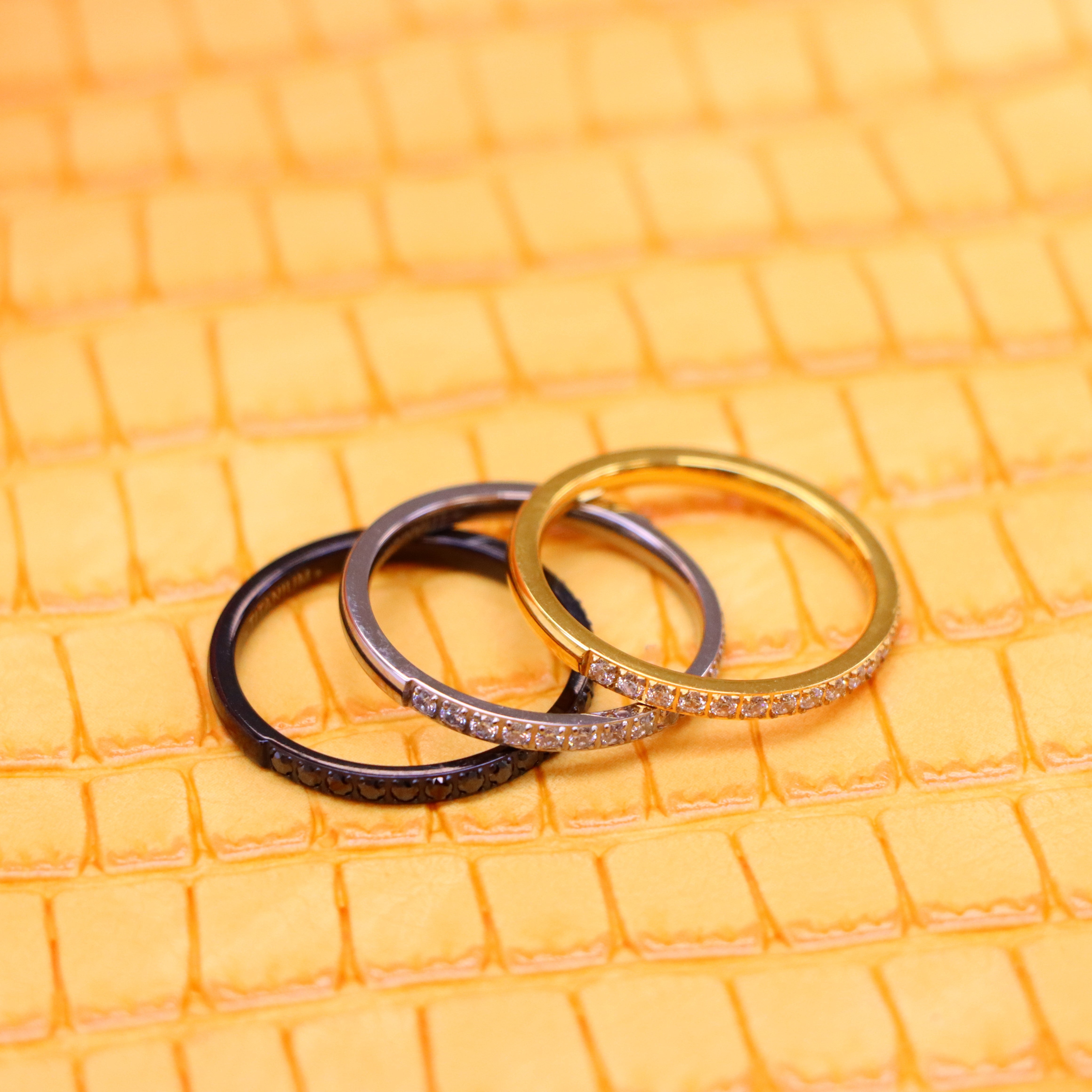 2mm Yellow, Black, Silver Titanium Half Eternity Titanium Ring with White cz stones on yellow and silver titanium rings and black CZ Stones on black titanium ring spreaded one on one left side view