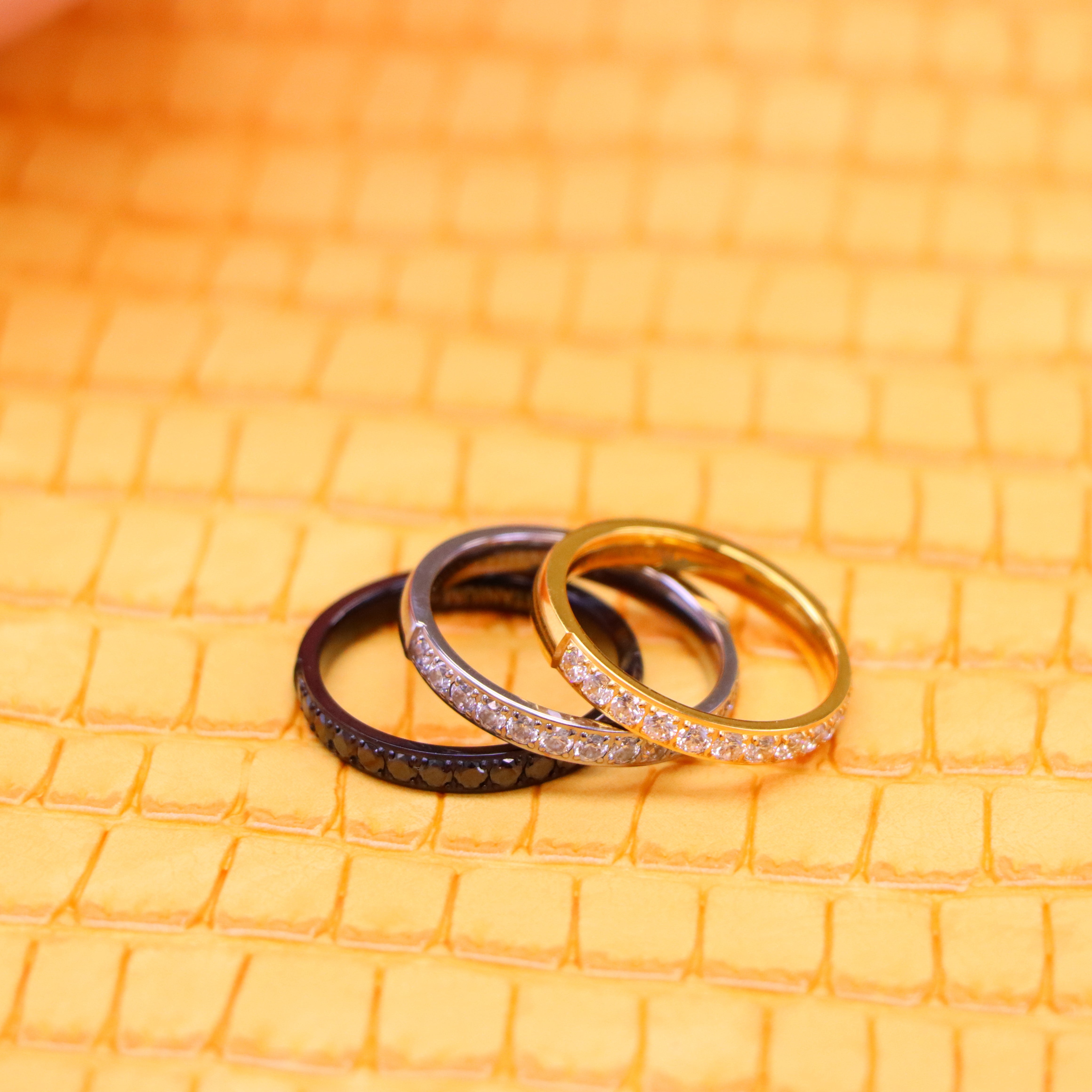 Highly recommended men's 3mm Titanium and yellow IP Plated Half Eternity black CZ ring and 3mm black IP Plated Half Eternity black CZ ring one on one spreaded view