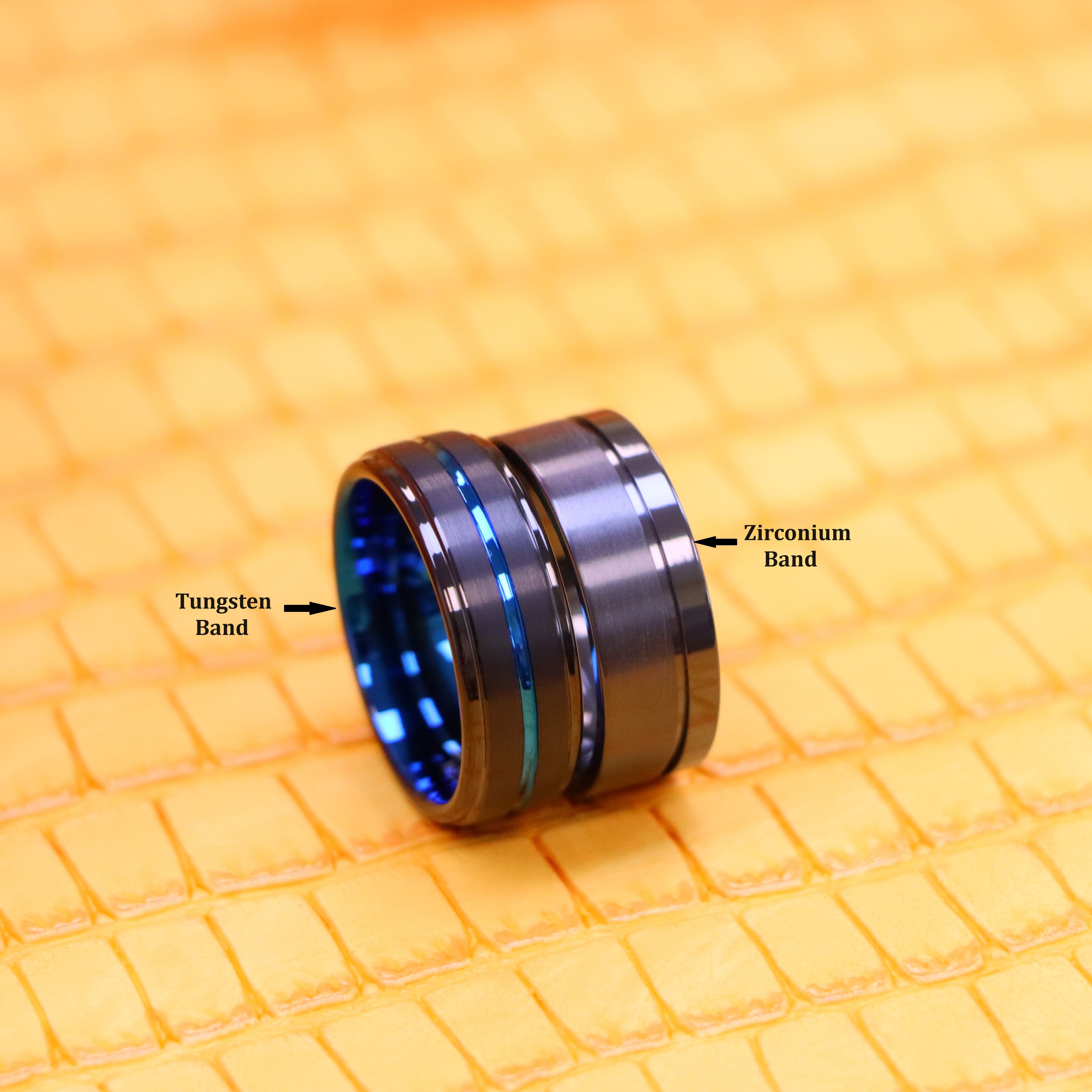 Two blue rings that includes one 8mm carbide tungsten band on the left side and one 8mm zirconium band on the right side