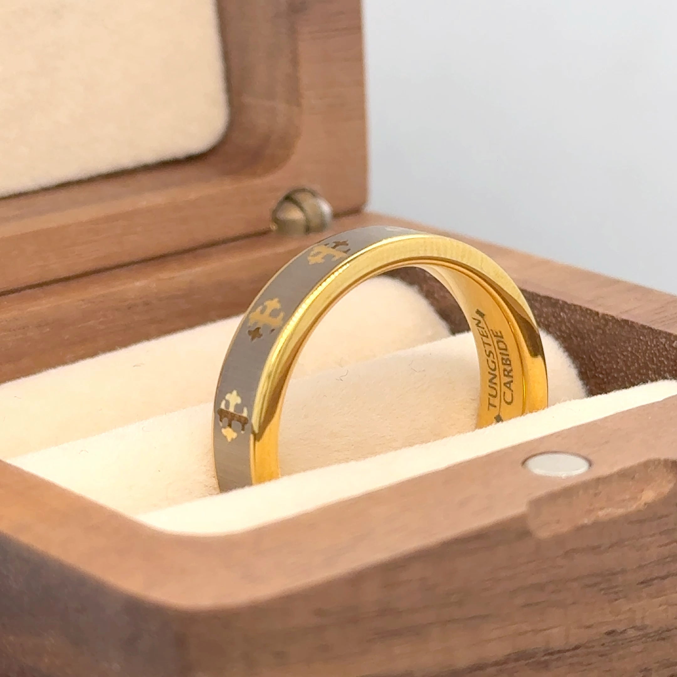 men's 5mm Yellow Gold Laser Engraved Crosses Design tungsten wedding band kept in a brown box in a front view